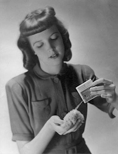 1942 Pouring Outdoor Girl Face Powder onto a puff from a spill-proof container